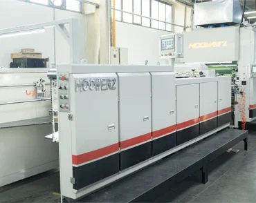 Industrial lamination machine used for coating and finishing printed materials in packaging production