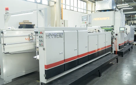 Industrial lamination machine used for coating and finishing printed materials in packaging production