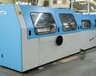 Industrial sewing machine used for stitching in packaging and print finishing