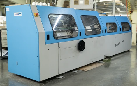 Industrial sewing machine used for stitching in packaging and print finishing